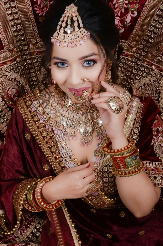 an asian woman in elaborate garb poses for a po