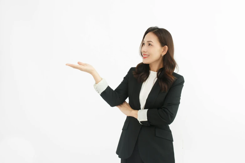 woman in business suit holding out soing in front of her