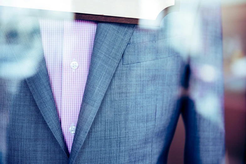 a blue suit and pink shirt sitting on display