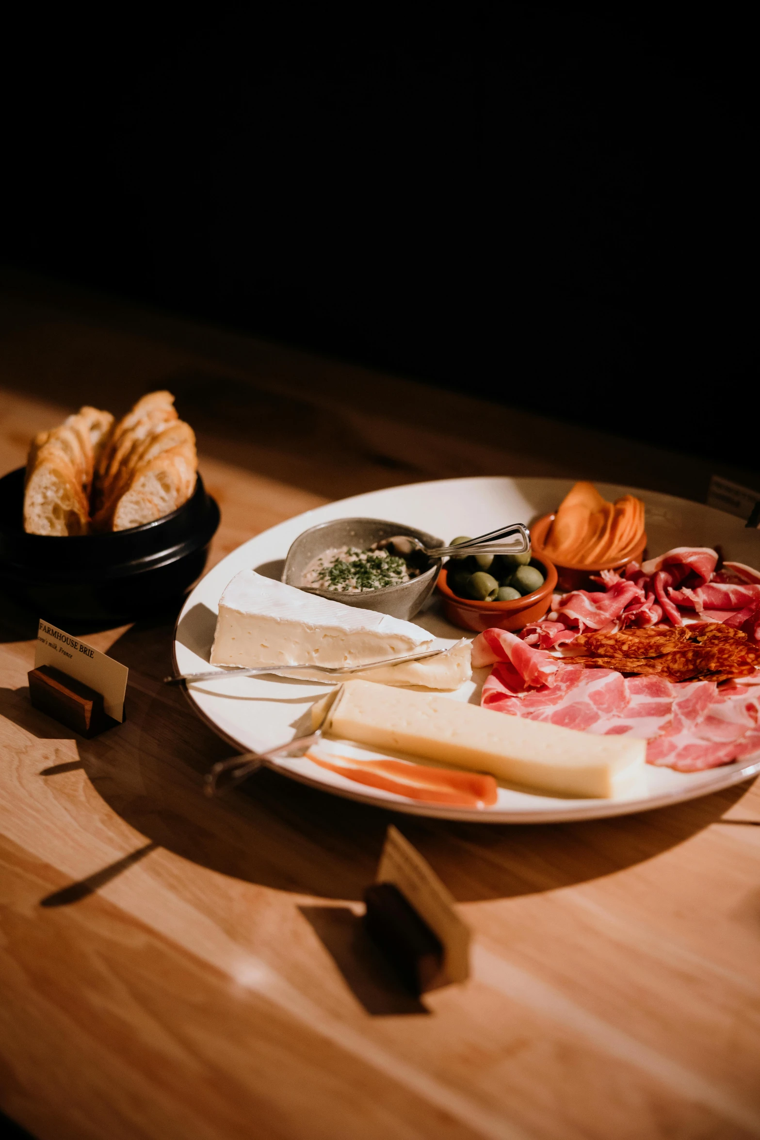 a plate of food and two plates of bread on a table