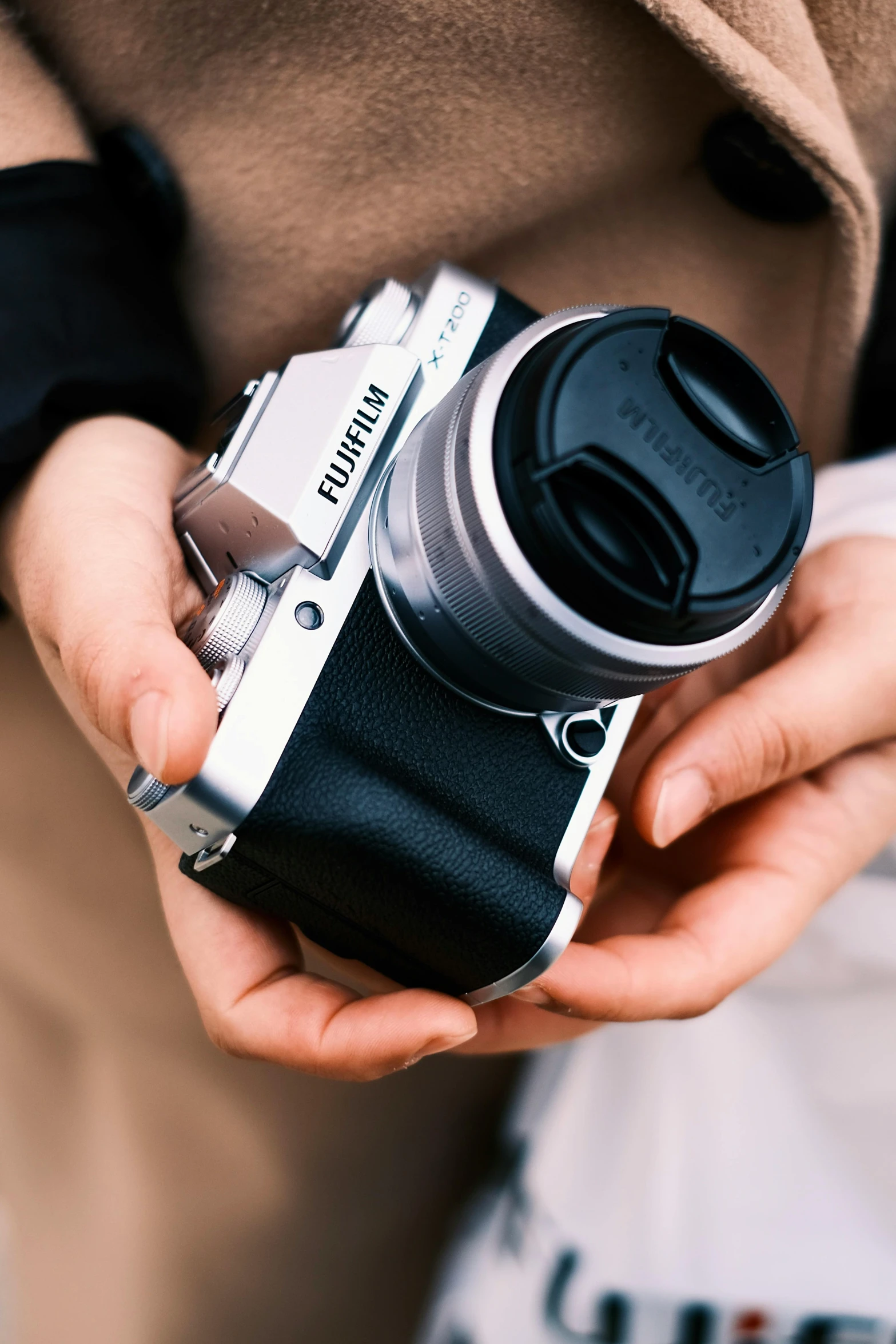a person holds up a small camera