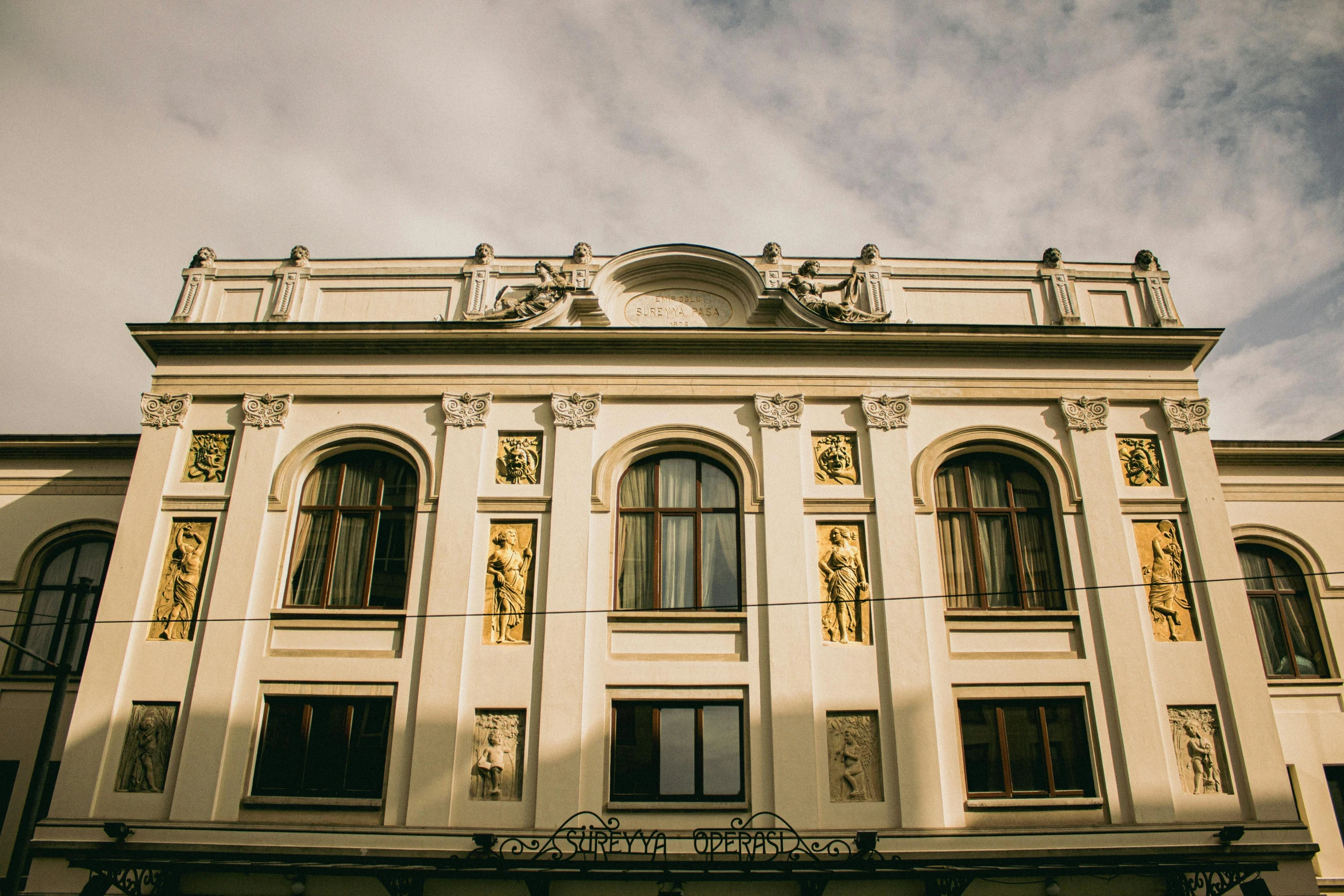 a brown and white building with a sky background