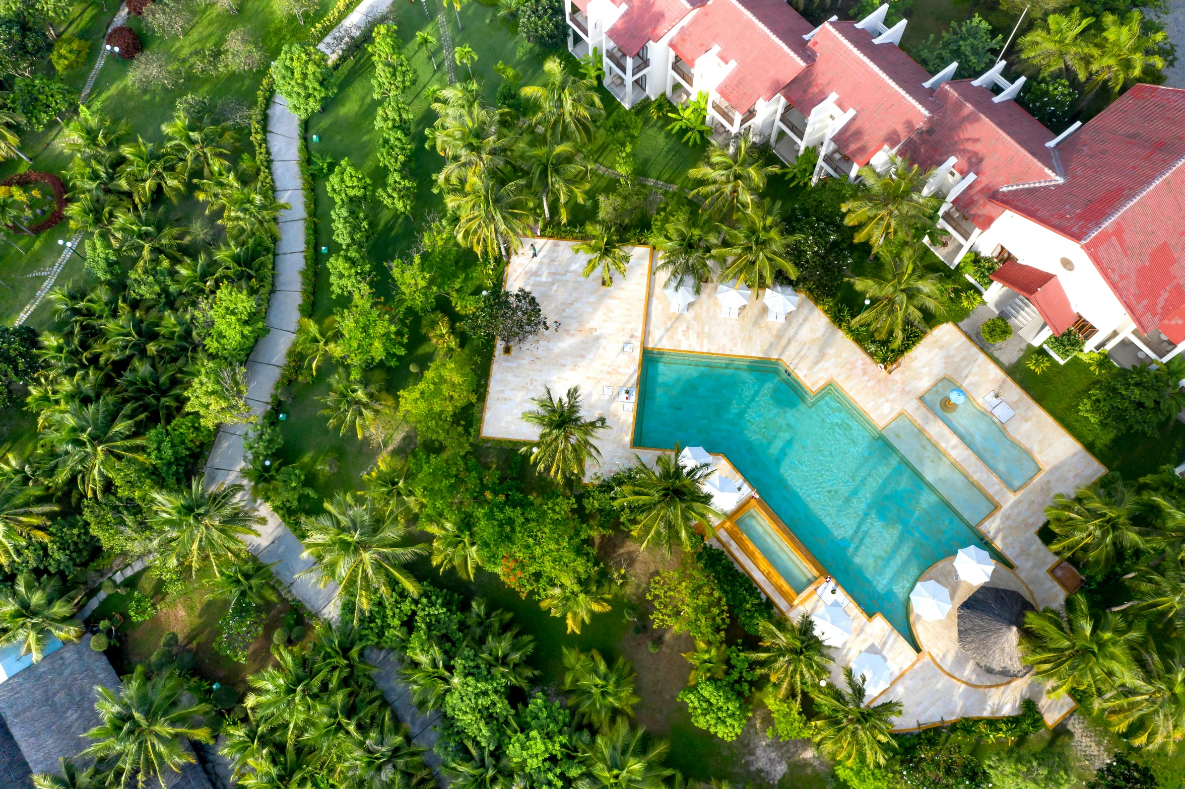 an aerial view shows a large garden, swimming pool and house