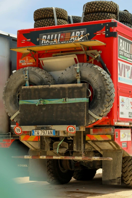 a large red truck sitting on top of a parking lot