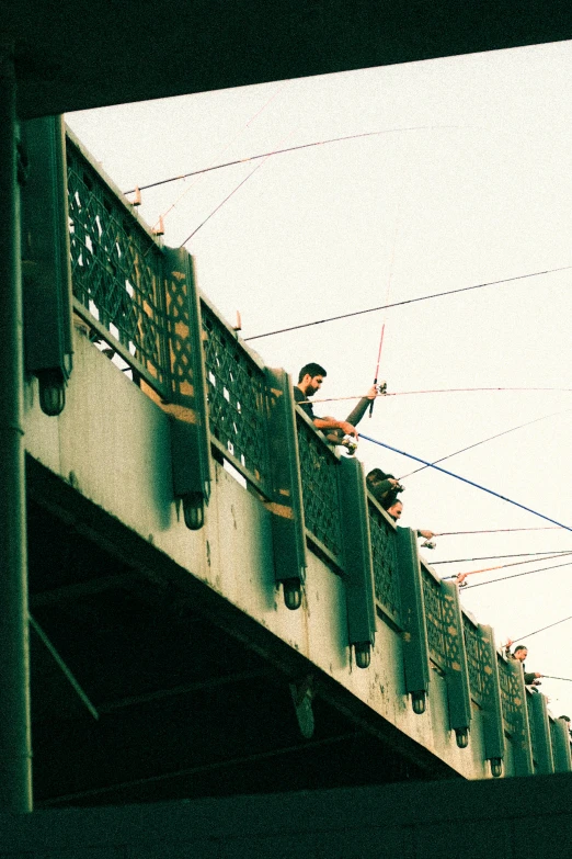 two men on the side of a bridge are getting ready to ski