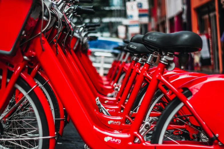 two rows of red bikes parked side by side