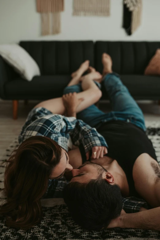 man and woman are laying on the floor and smiling