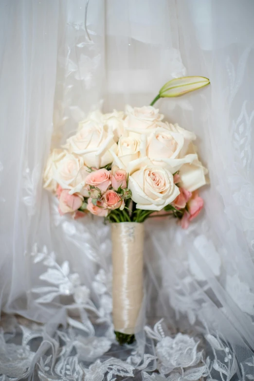 a bouquet is laid in a vase with veil