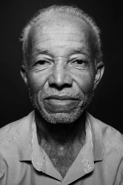 a black and white po of an old man with eye makeup