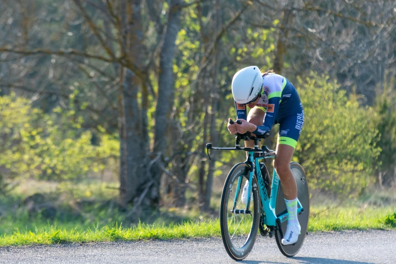 a person riding on top of a bike on a road