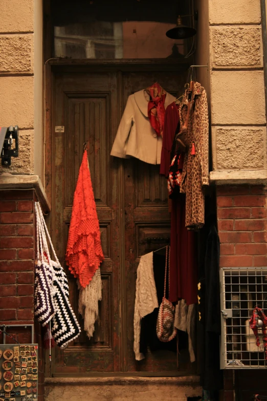 there are many clothes hanging on the door way