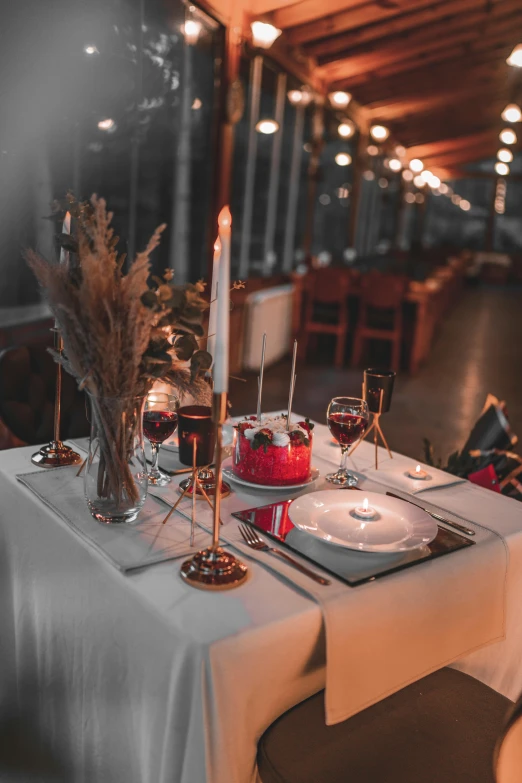 a table with many plates and some wine glasses on it