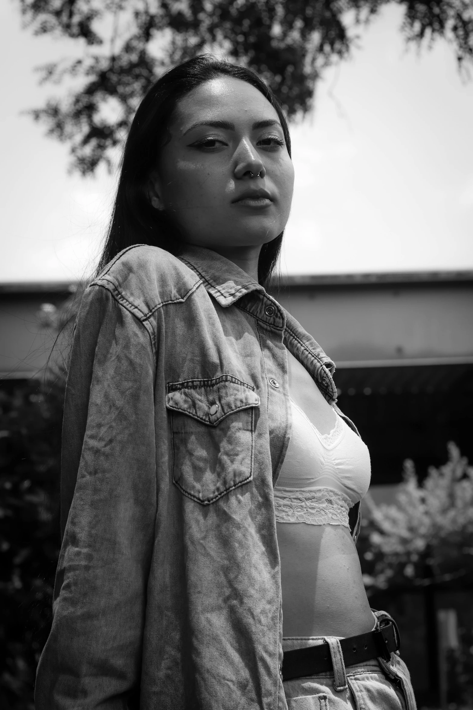 an asian woman in a shirt and jeans posing for the camera