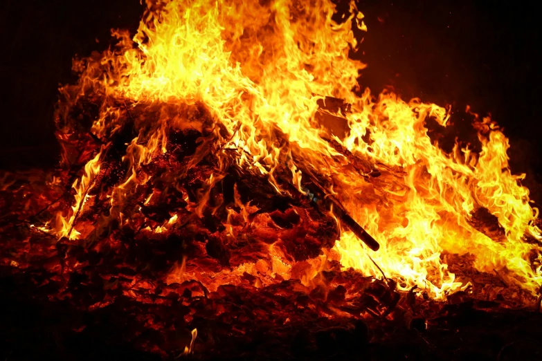 a big bonfire with many sticks burning