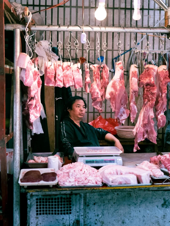 a woman is selling meat in the street