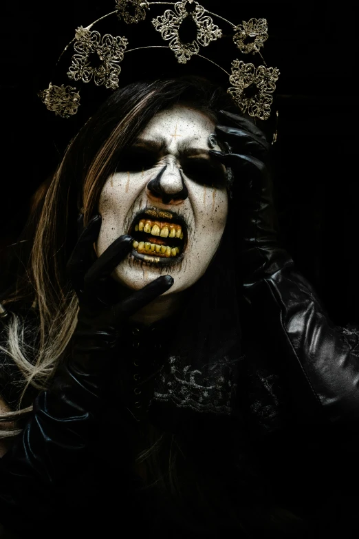 a creepy woman has teeth painted gold