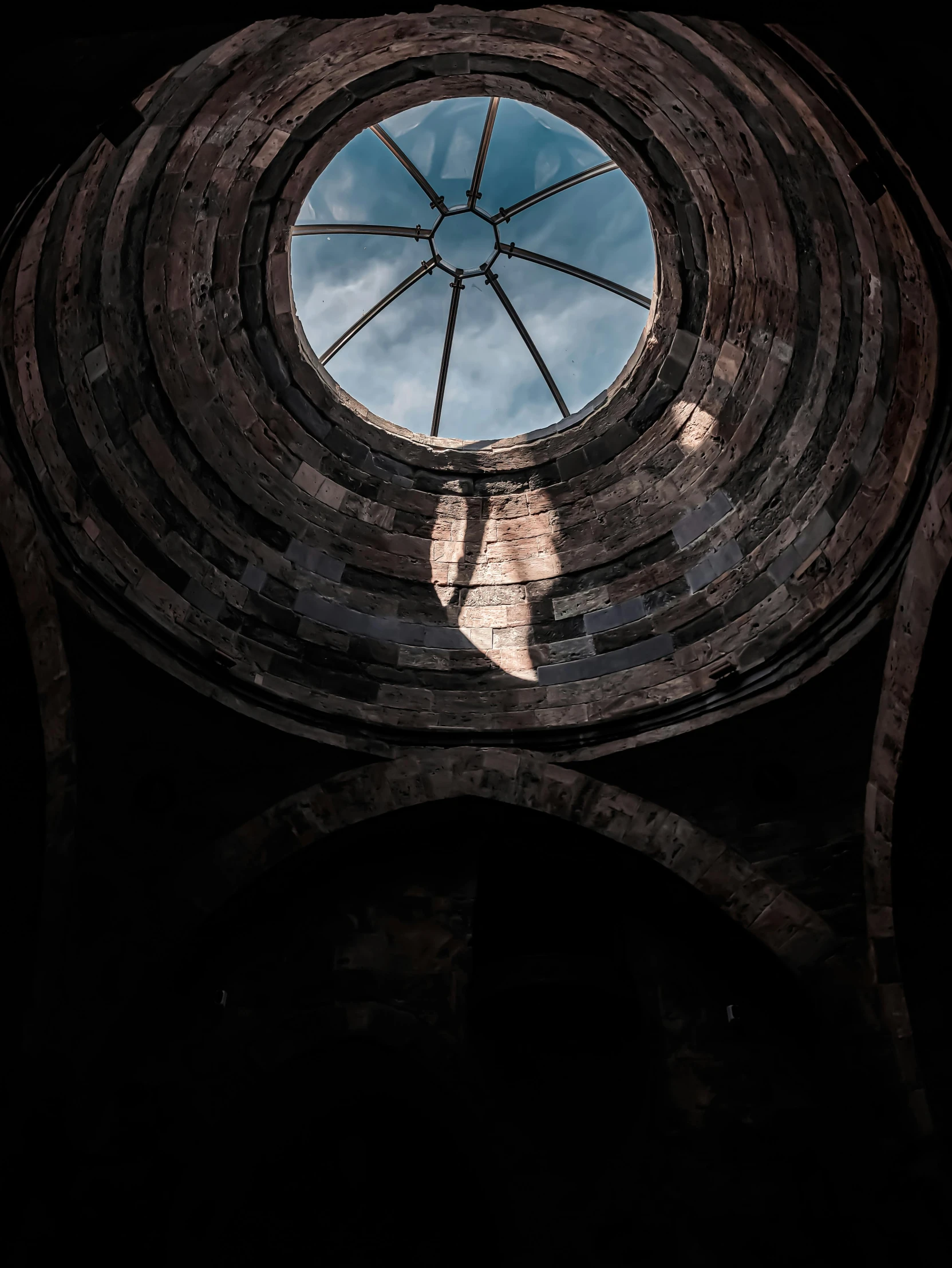 the sky is partially visible through a circular window