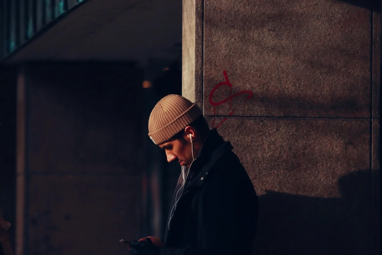 a man looks at his cell phone in the dark