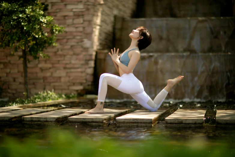 a woman doing yoga outside in the sun