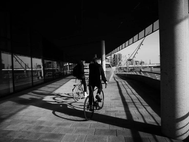 the person rides their bike on the sidewalk