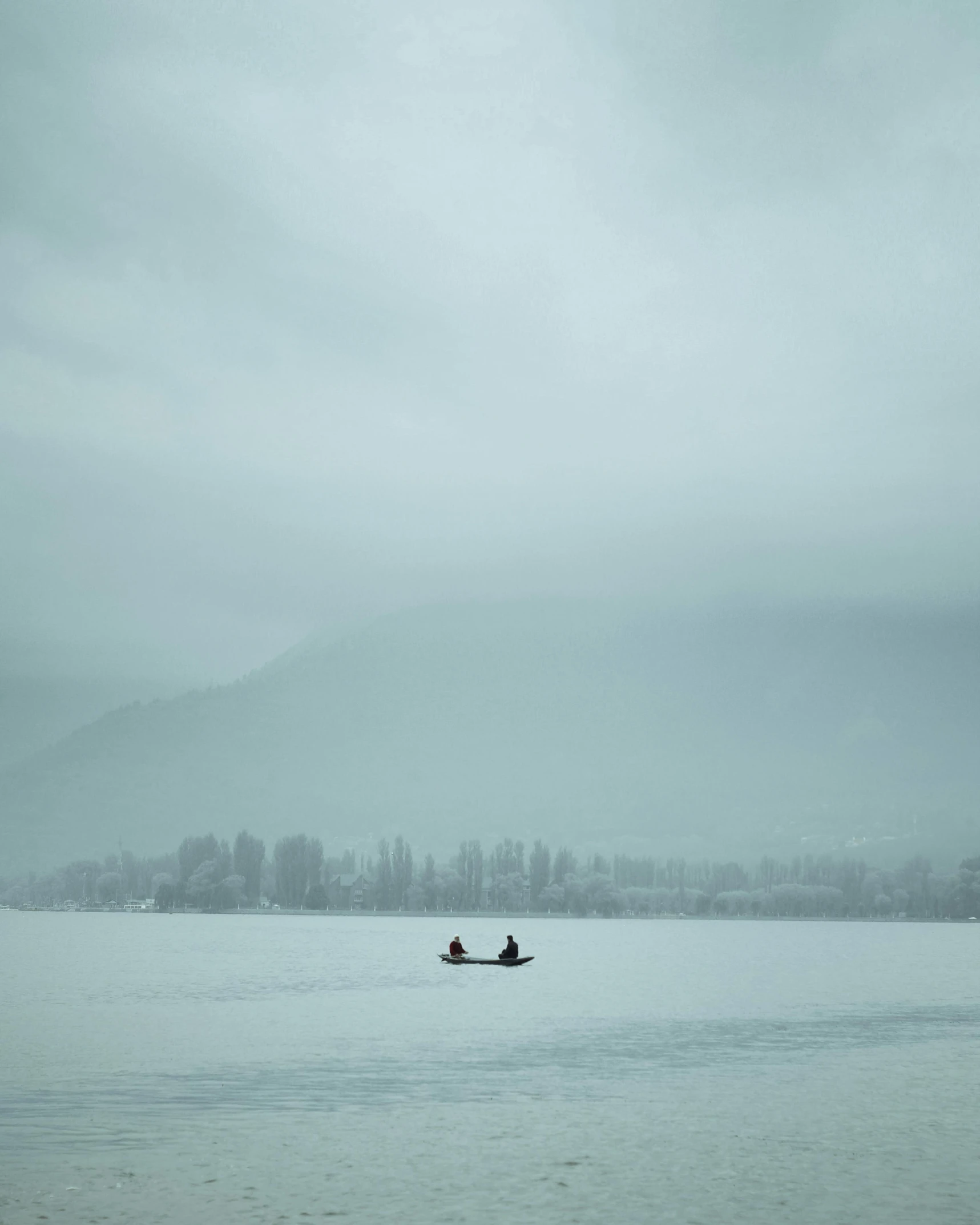 people are in a small boat on a lake