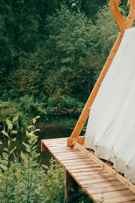 a wooden bed frame near a body of water