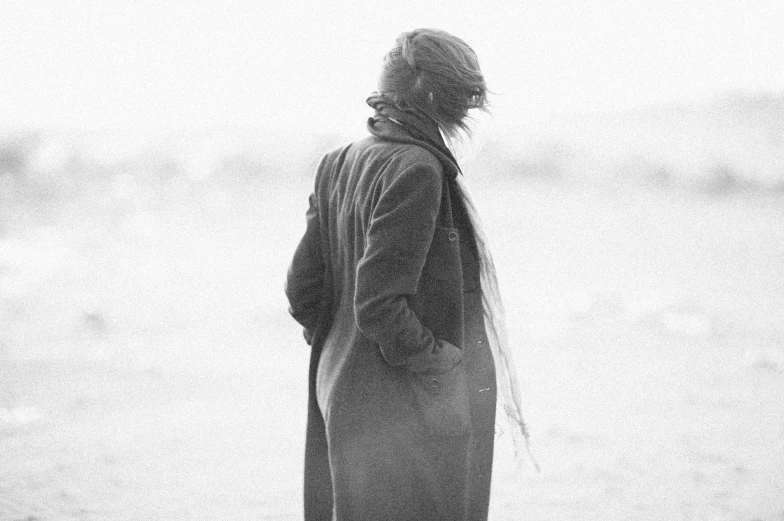 a person standing near the ocean looking over the water