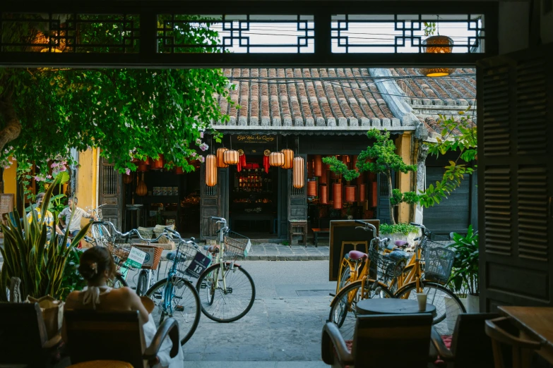 there are bicycles parked near a building and trees