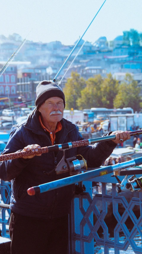 a person standing with some fishing rods by them