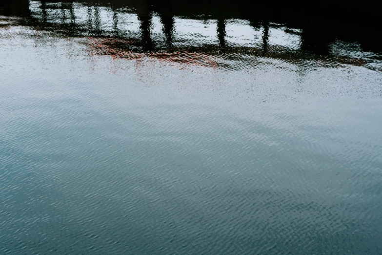 a river with a bridge spanning the width of it