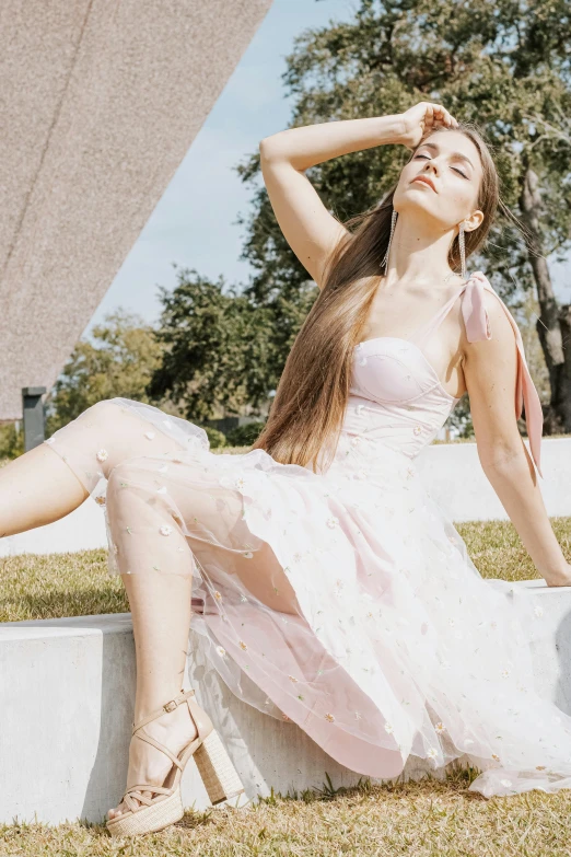 a pretty young lady wearing a sheer pink dress