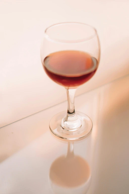 a glass of wine on a light counter