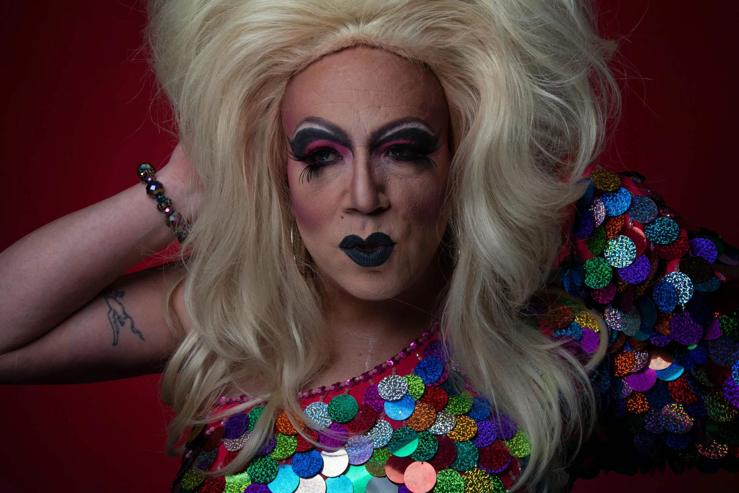 the woman is covered with colorful beads and makeup