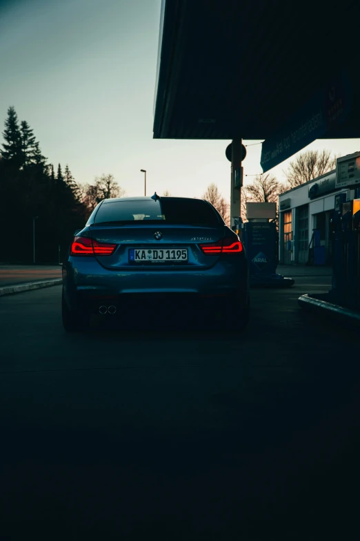 car parked by gas station at dusk time