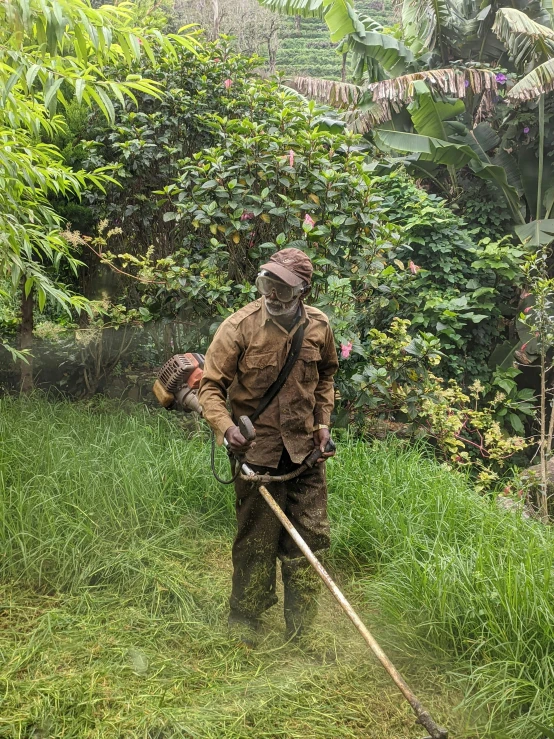 a man in camouflage carrying a stick and wearing military gear