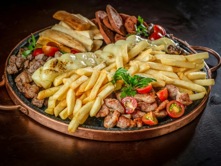 this copper tray has a dish of different types of foods