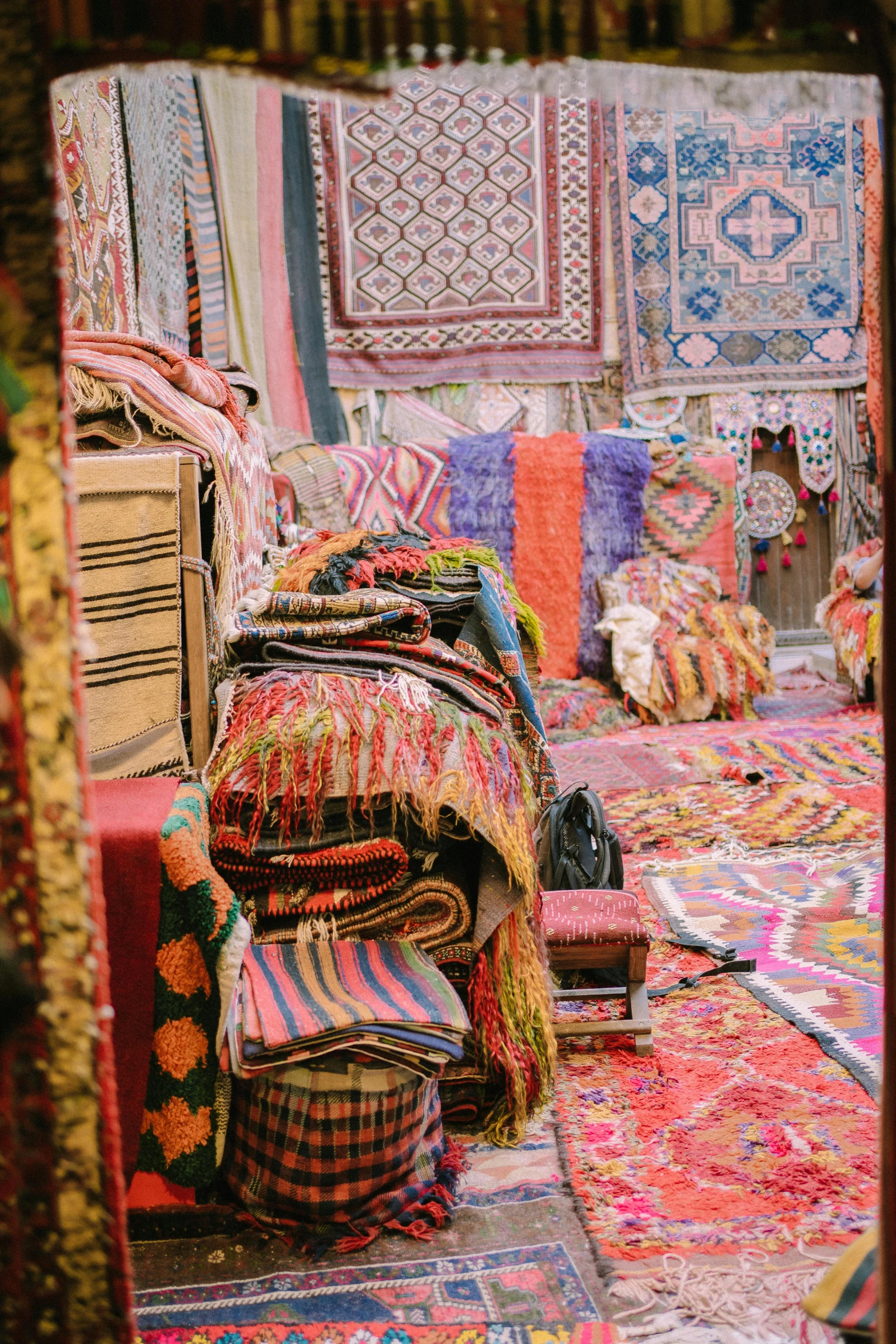 various different colored cushions and blankets on the floor