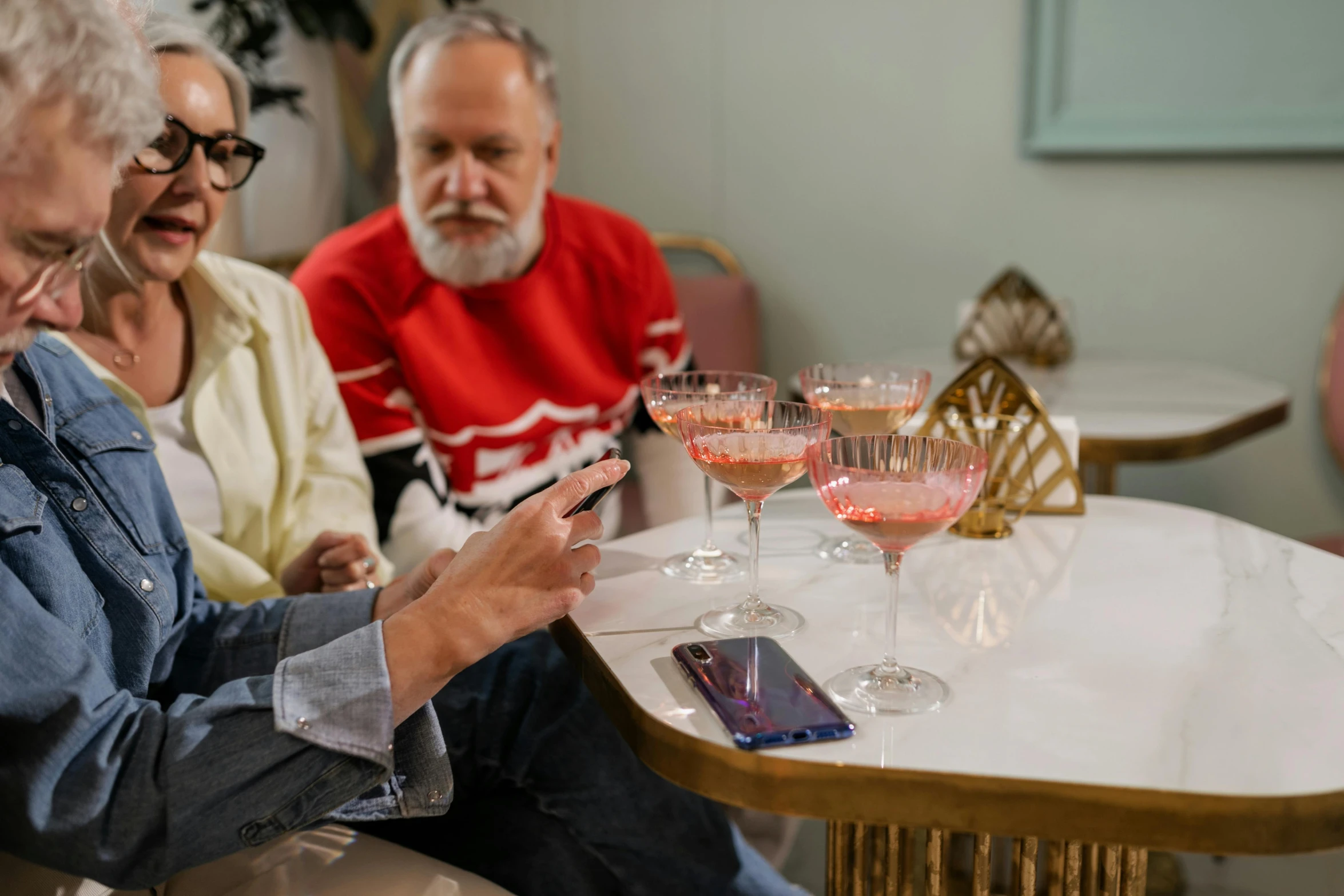 an elderly couple tasting wine on the patio