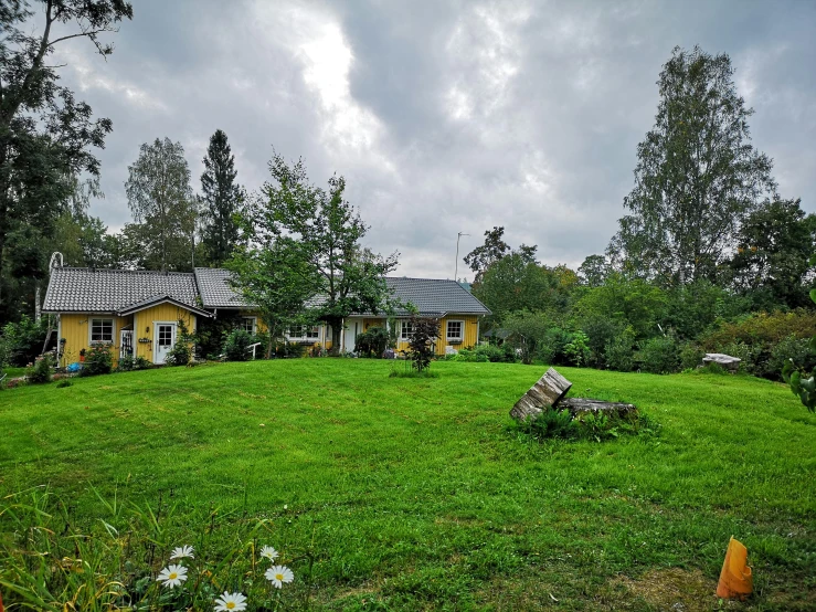 a large yellow building is located near some trees and grass