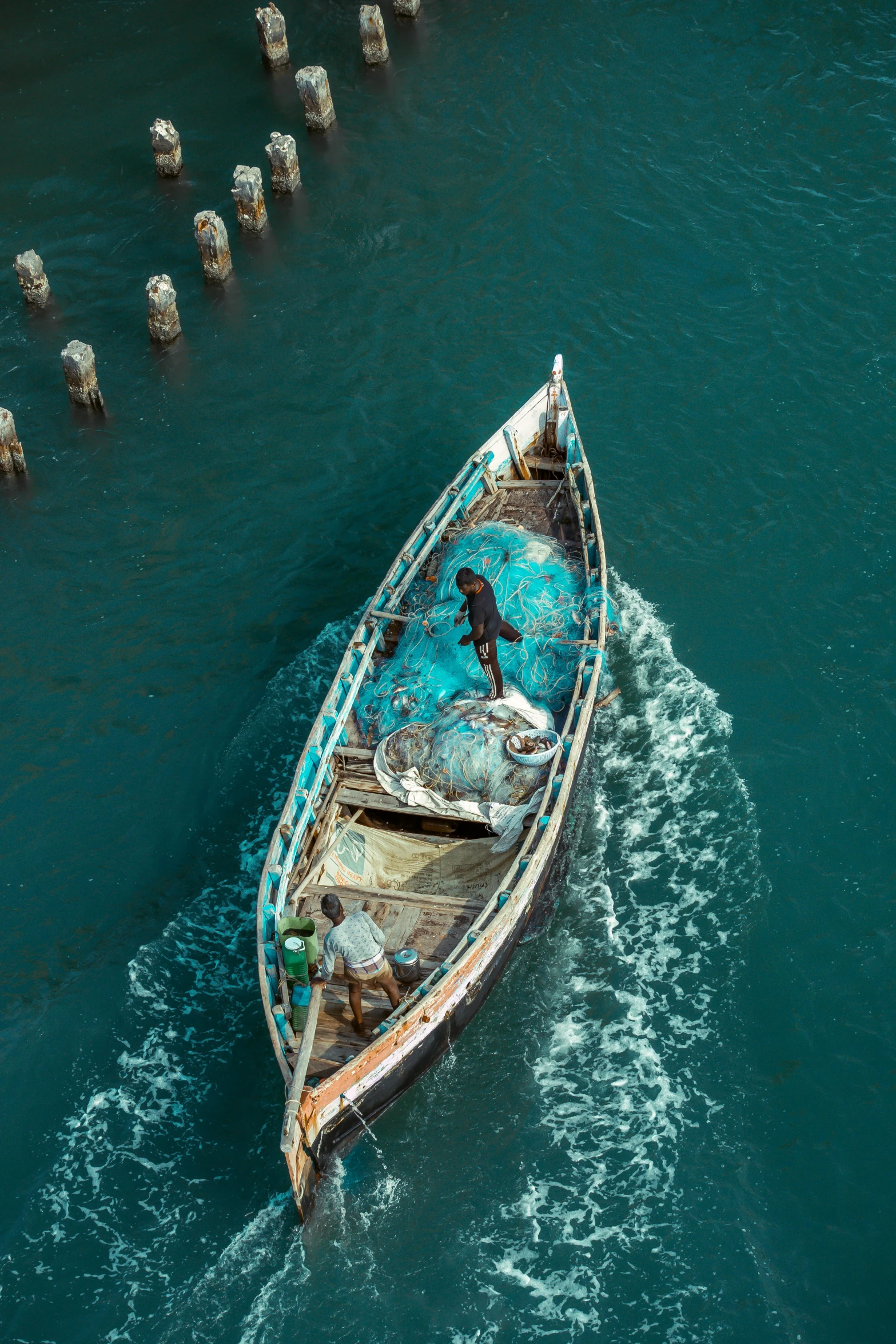 an abandoned boat is in the middle of a body of water