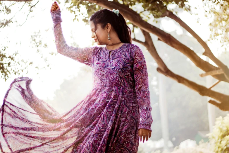 woman in purple dress spinning her shaw around