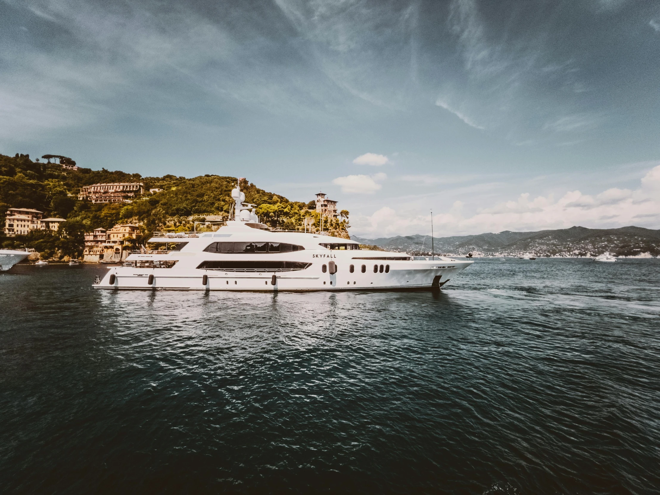 a large boat in the water near a shore