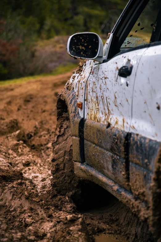 the mud is all over the white car