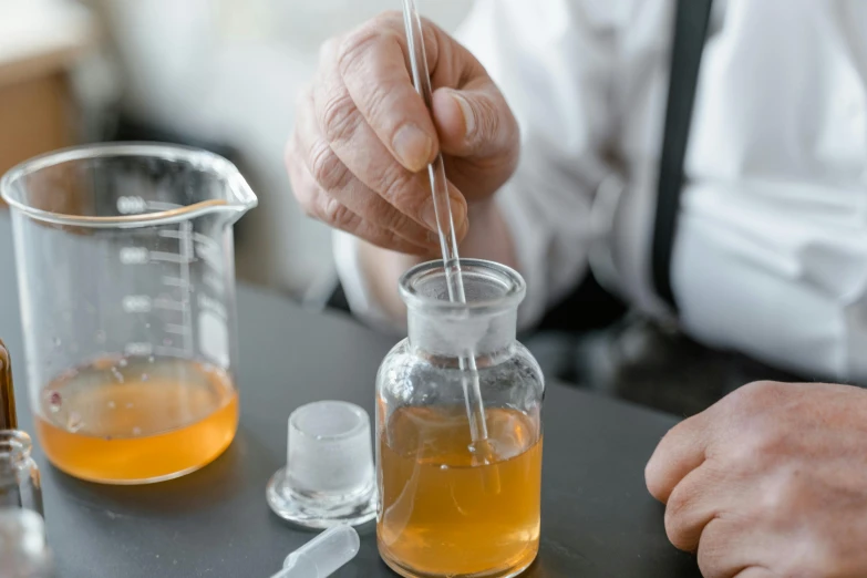 an older man makes a beakle using liquid