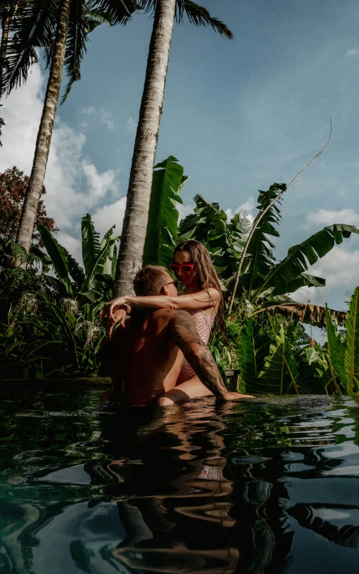 an image of two people that are hugging in the water