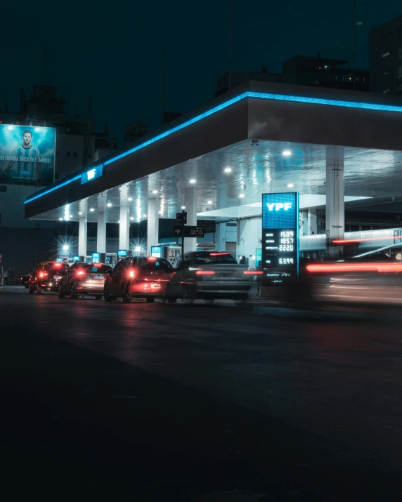 a gas station is lit up with colorful lights