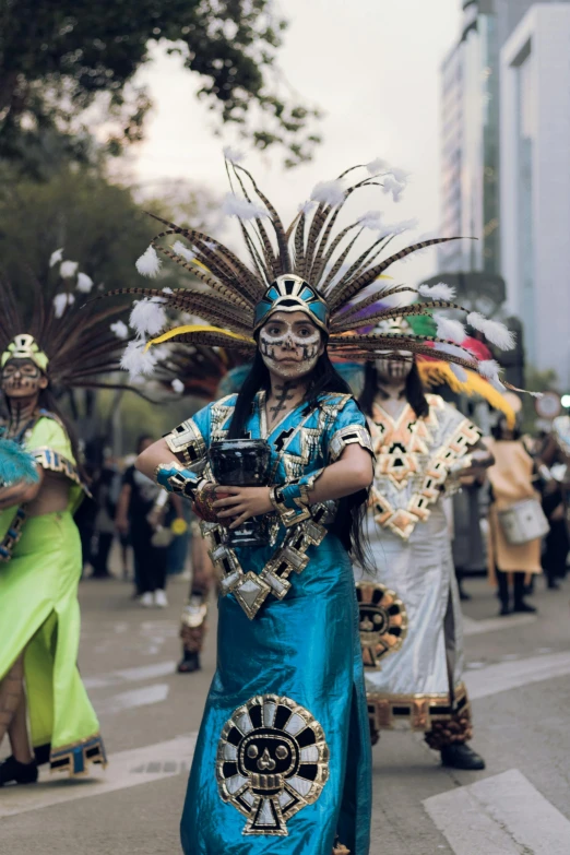 a woman is wearing an elaborate head piece while walking