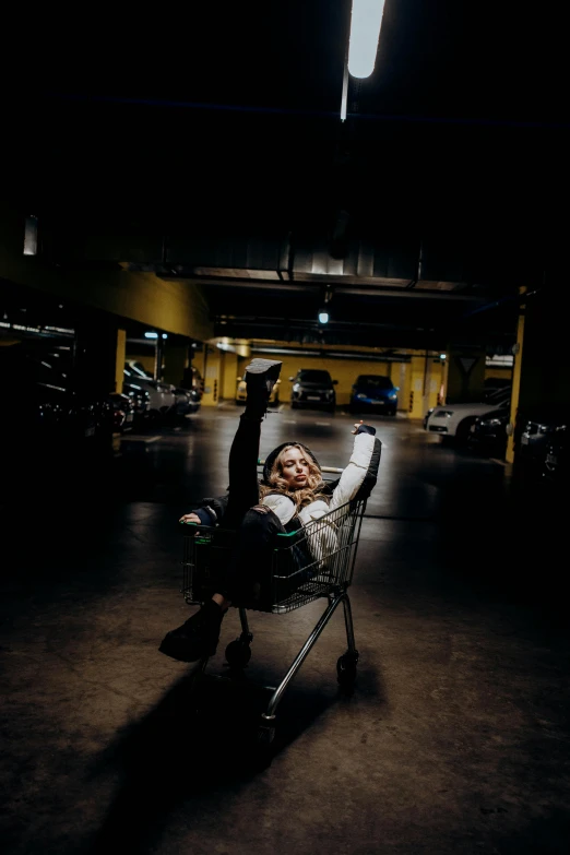 a person is on a small shopping cart in an empty parking lot