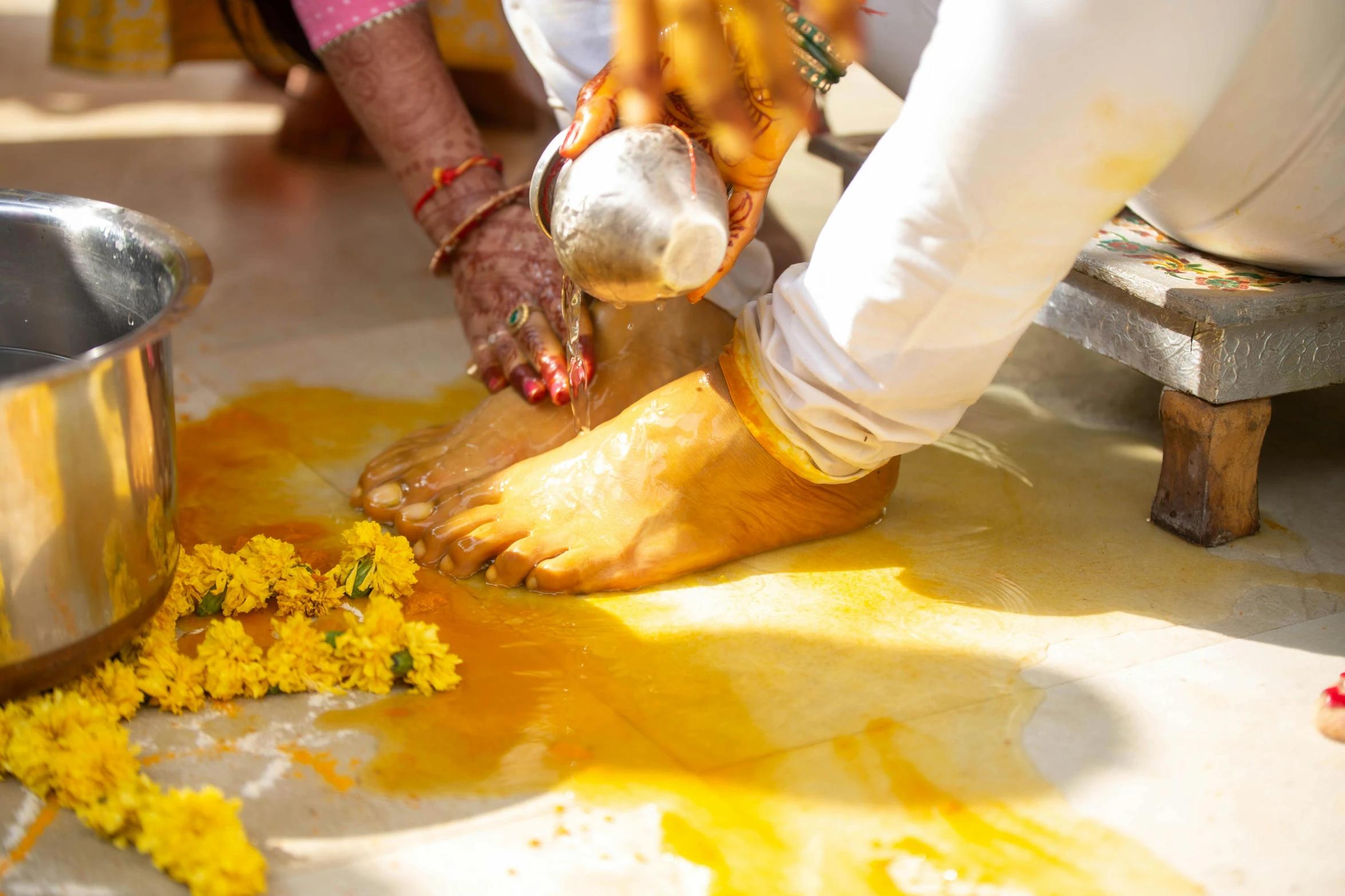 yellow dye is spilled on the floor as a person places a sauce in them