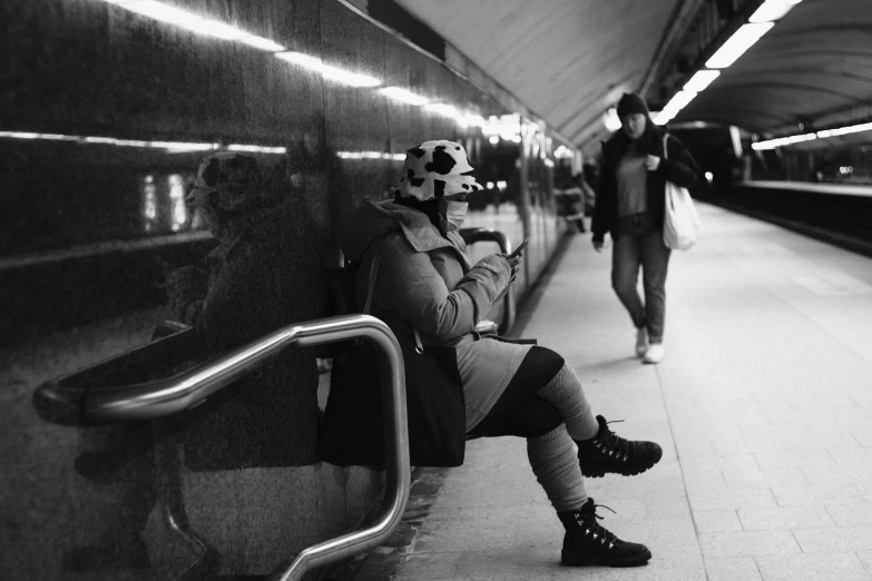 people are sitting in an empty train station